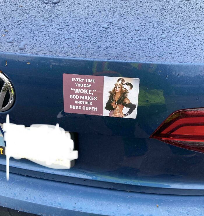 Sticker on a blue car trunk with a humorous message about woke culture and drag queens, one of the most hilarious bumper stickers.