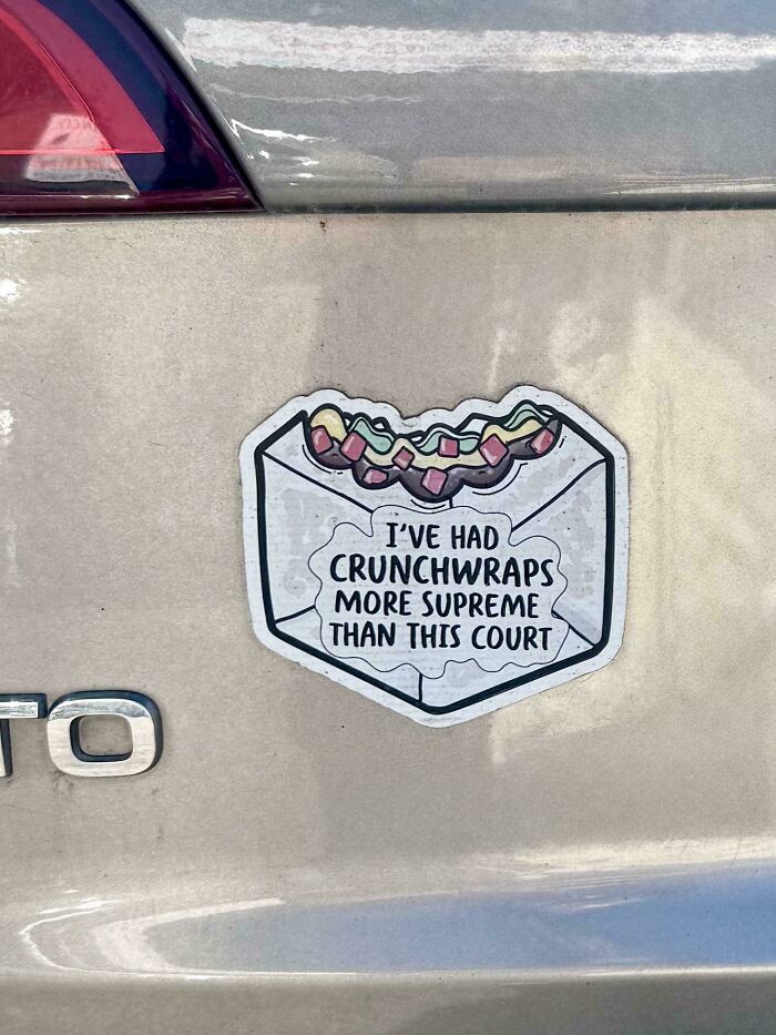 Funny and unhinged bumper sticker on a car showing a Crunchwrap with a sarcastic Supreme Court joke.