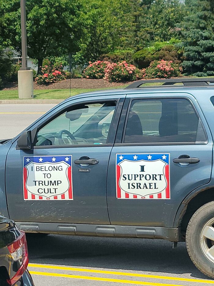 SUV with two large political bumper stickers, one saying I belong to Trump cult and the other I support Israel.