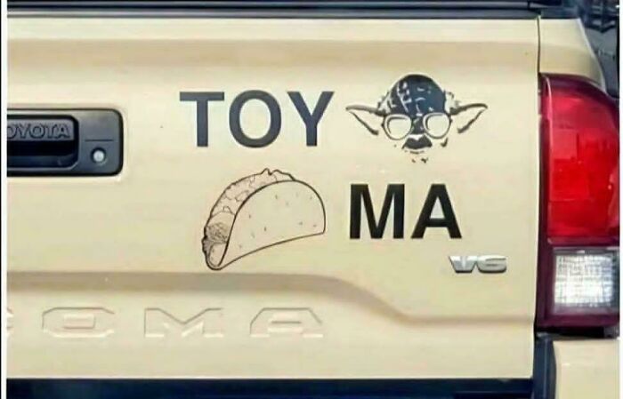 Funny and unhinged bumper sticker on a beige truck tailgate featuring a taco and Yoda illustration.