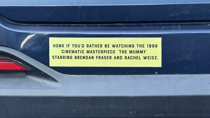 Bumper sticker on a car bumper humorously referencing the 1999 movie The Mummy starring Brendan Fraser and Rachel Weisz.