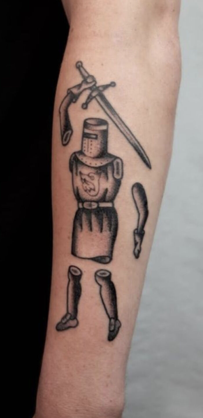 Tattoo of a disjointed medieval knight holding a sword with detached arms and legs, an example of truly awful tattoos.