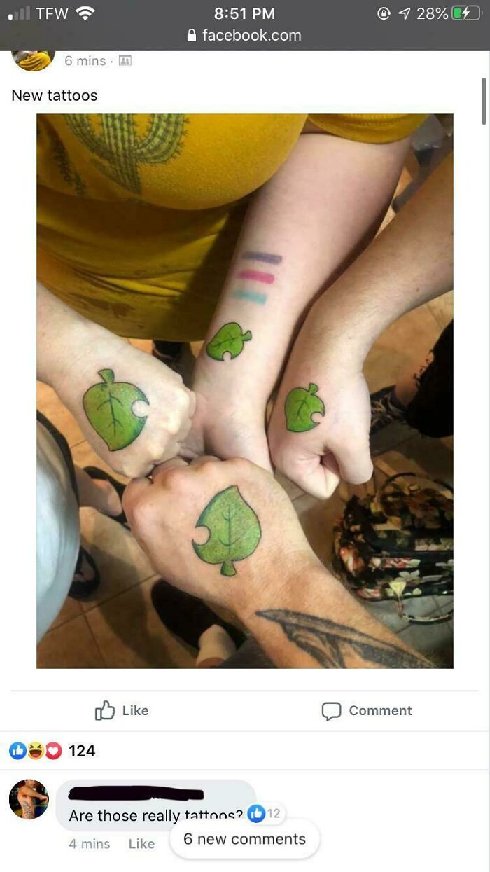 Four fists shown with matching green leaf tattoos, showcasing truly awful tattoos that are funny and permanent.