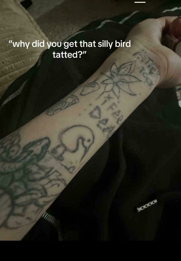 Arm covered in poorly drawn tattoos including a simple bird and flower, showcasing truly awful tattoos that are funny and tragic.