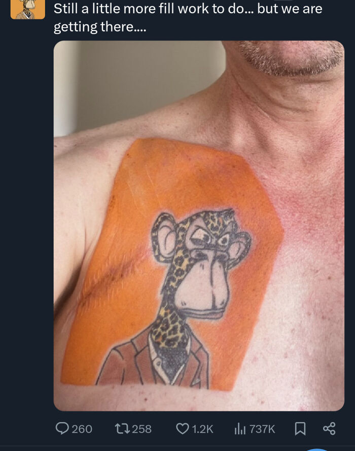 Tattoo of an angry cartoon monkey with a leopard pattern on shoulder, surrounded by orange ink fill work in progress.