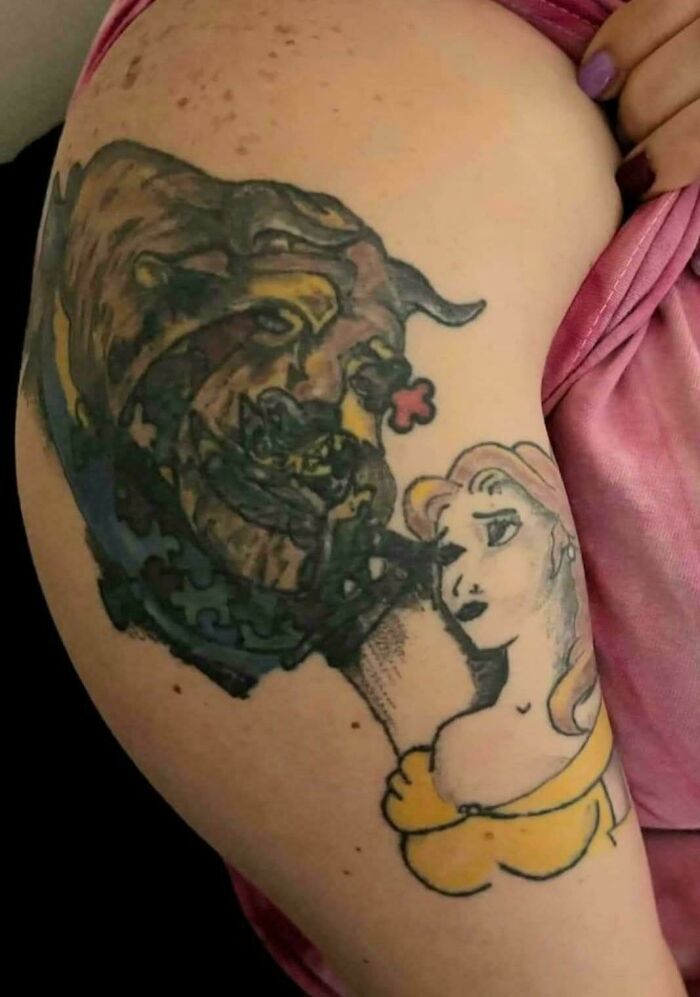Tattoo of a woman and beast with distorted and unclear details, one of the truly awful tattoos that are funny and tragic.