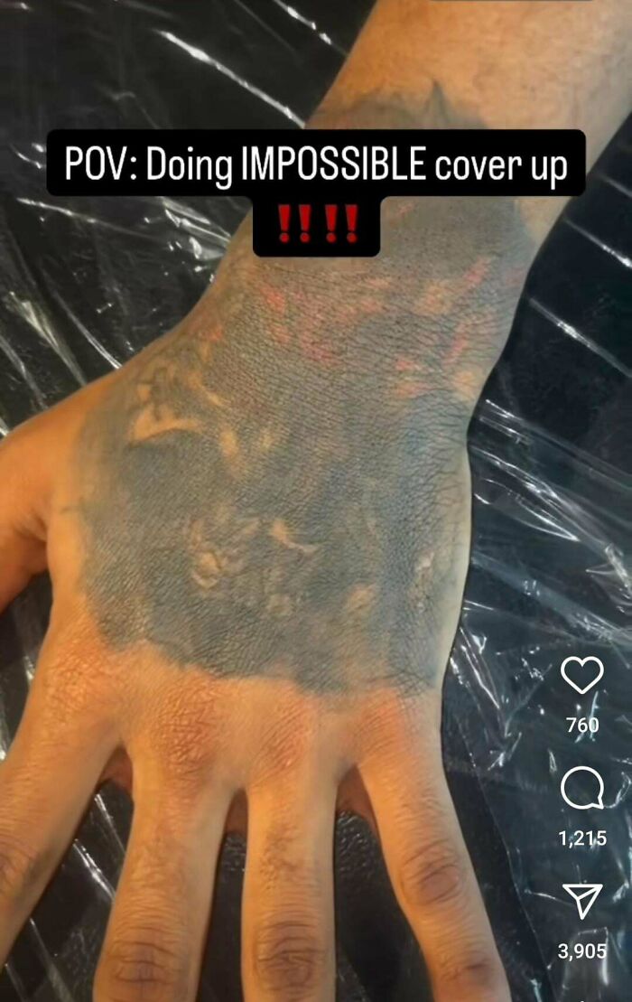 Hand with a large, poorly done black tattoo cover-up that looks truly awful and difficult to fix.