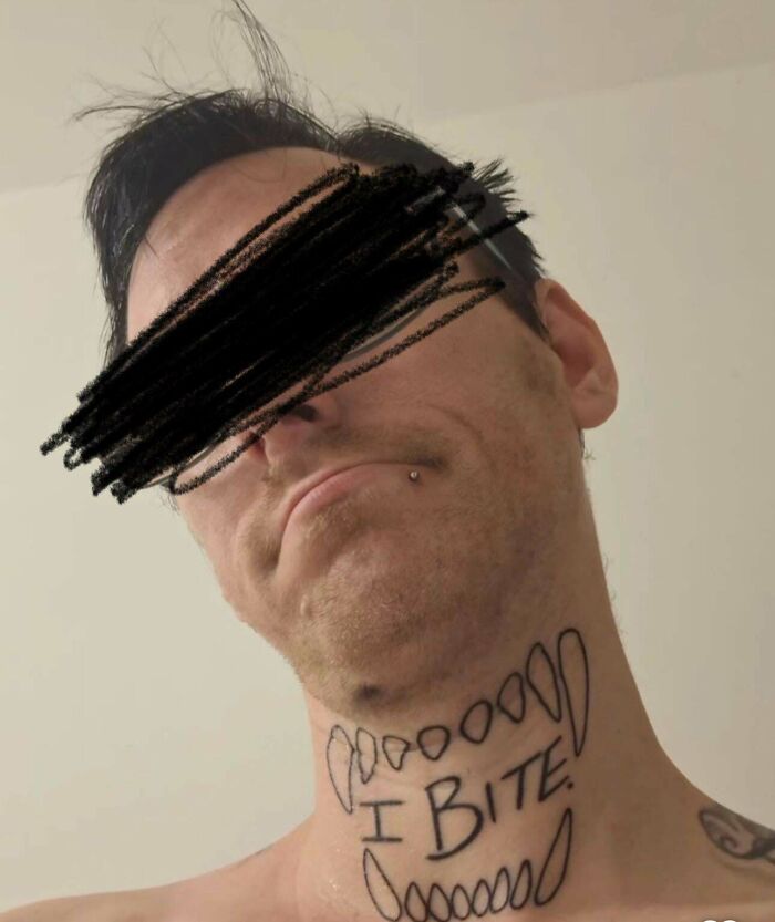 Man with a neck tattoo of cartoonish teeth and the words I BITE, one of the truly awful tattoos that are funny and tragic.