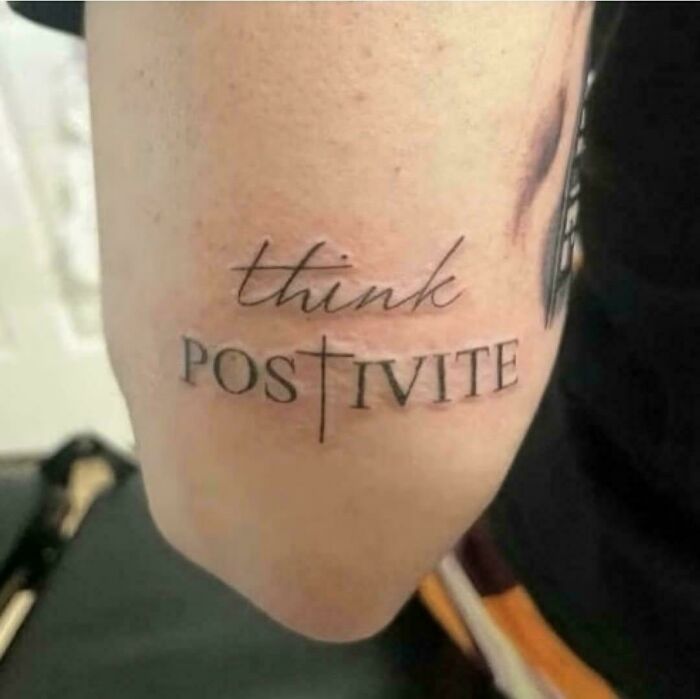 Tattoo on arm with misspelled phrase featuring the word positive as a truly awful tattoo example.