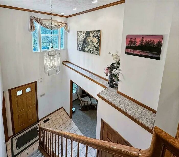 Interior view showcasing a mansion-inspired entryway and staircase, reflecting a Temu version of luxury architecture.