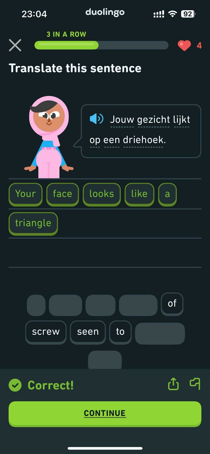 A Duolingo language app displays a verbal knockout, a Dutch sentence that translates to Your face looks like a triangle.
