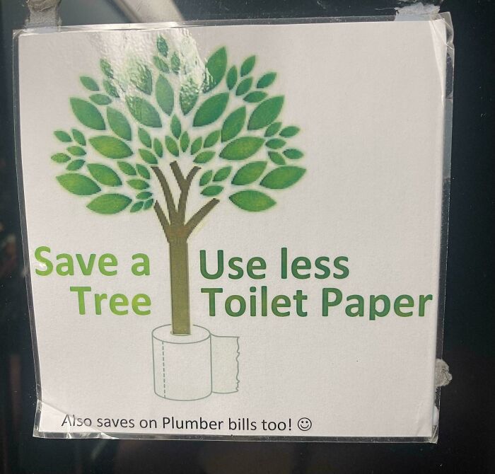 A sign with poor design humorously encourages using less toilet paper to save trees.