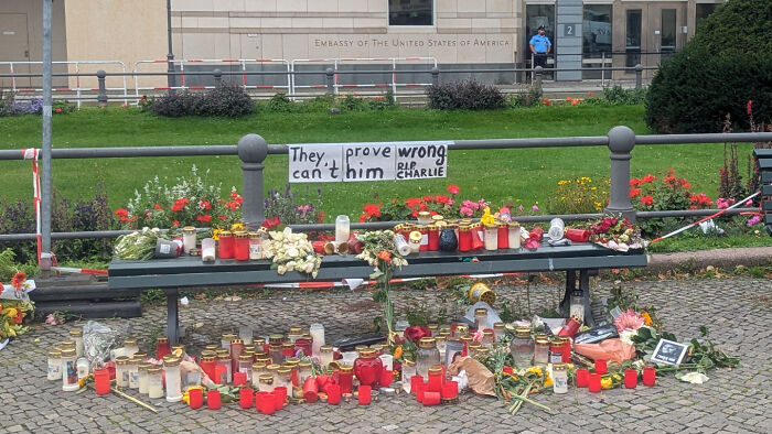 A hilariously confusing message on a sign that reads 'They prove wrong can't him R.I.P. Charlie' above memorial candles.