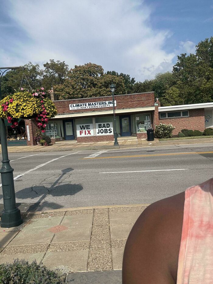 A hilariously confusing message on a sign reads 'WE BAD FIX JOBS' on a building for Climate Masters, Inc.
