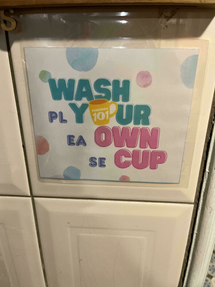 A sign with poor design reads Wash Ply Your Ea Own Se Cup, demonstrating a hilariously confusing message.