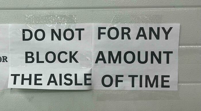 A hilariously confusing sign design that reads Do Not For Any Block Amount The Aisle Of Time, showcasing poor sign design.