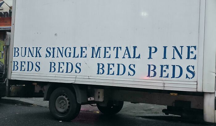 A hilariously confusing message on the side of a delivery truck: Bunk Single Metal Pine Beds Beds Beds Beds.