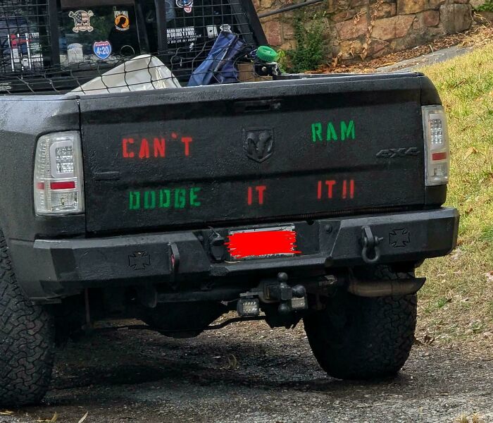 A hilariously confusing message on a pickup truck tailgate: Can't Ram, Dodge It!!