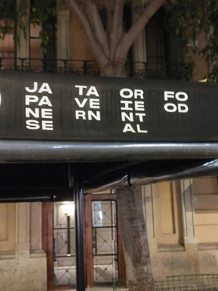 A restaurant sign with poor sign design for Japanese Tavern Oriental Food, causing a confusing message.