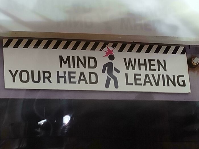 A hilariously confusing sign design warning to mind your head when leaving.