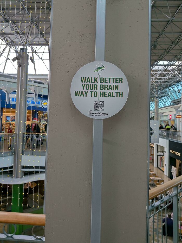 A hilariously confusing sign design in a mall reads: Walk Better Your Brain Way To Health.