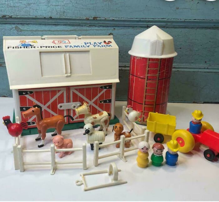 Vintage Fisher-Price play family farm toy set with barn, silo, tractor, animals, and peg people nostalgic for childhood memories