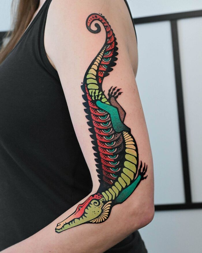 A colorful alligator tattoo on an arm, one of many stunning tattoos people wear forever.