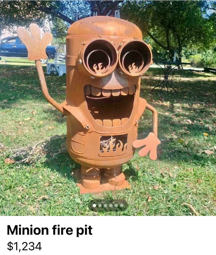 A rusty Minion fire pit sculpture, a DiWHY creation that failed miserably, stands in a grassy yard.