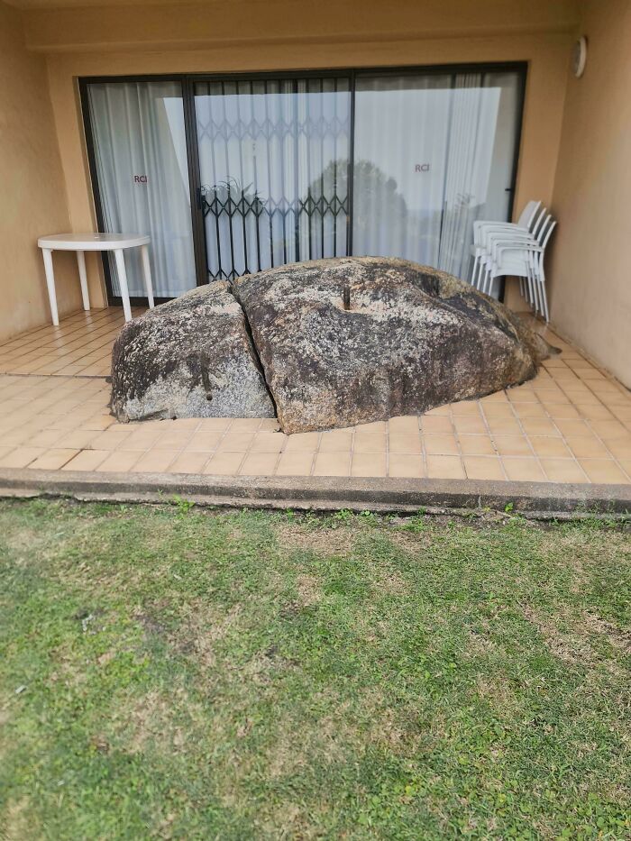 A large boulder on a tiled patio, blocking a sliding glass door. A DiWHY design failure, needing a fix.