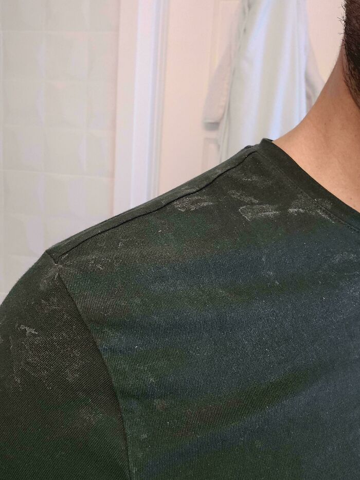 Close-up of a dad's shoulder, covered in white lint, showing the everyday life of dads.