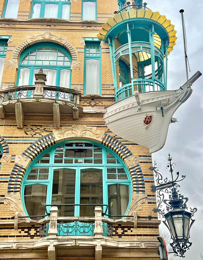 Architecture lovers will admire this unique building with turquoise windows, ornate balconies, and a ship-shaped balcony.
