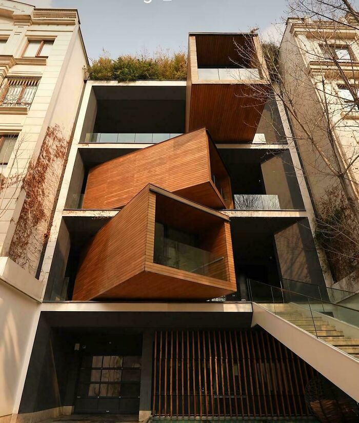 Impressive architecture with modern wooden box-like extensions on a multi-story building, an interesting sight for architecture lovers.