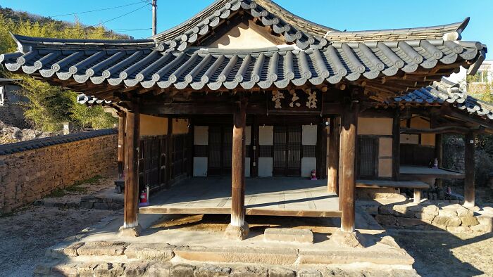 Traditional Korean architecture with a tiled roof and wooden columns, impressive for architecture lovers.