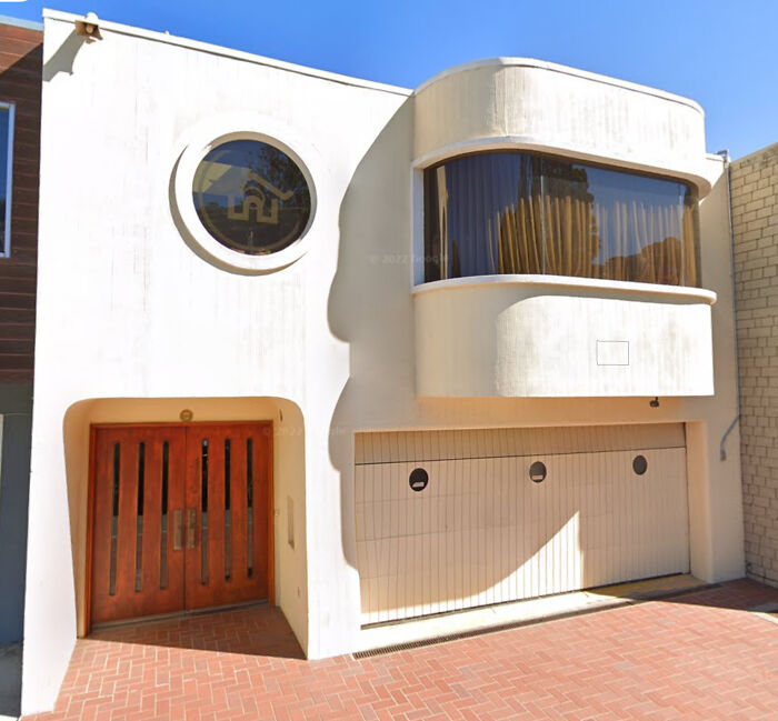 Architecture lovers will appreciate this impressive building with its striking circular window, curved bay, and unique garage doors.
