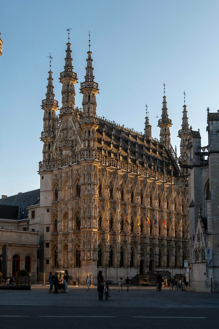 A magnificent historic building with intricate architecture and many spires, bathed in golden light. Architecture lovers will be impressed.