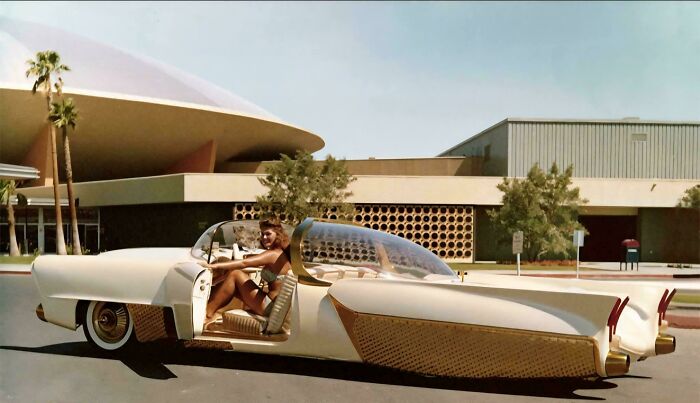 Retrofuturism vintage futuristic car with clear bubble top and woman driver