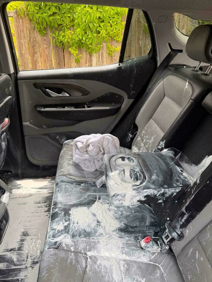 Car mechanic showing messy car interior covered in white powder, capturing evidence for others to believe the condition.