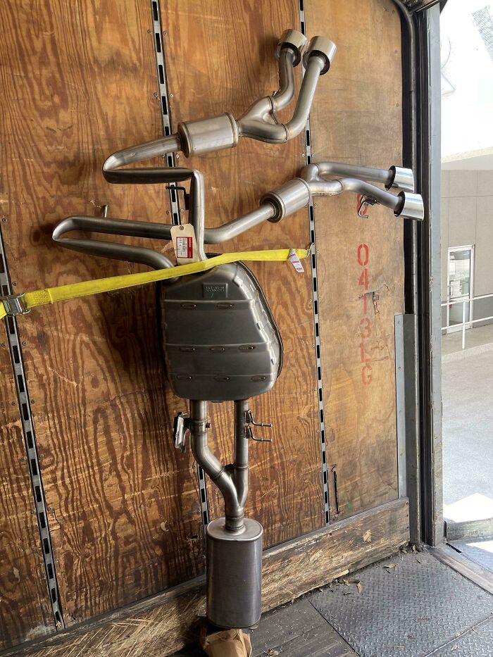 Car mechanics' unusual exhaust system setup taken to prove the complexity of repairs they handle.