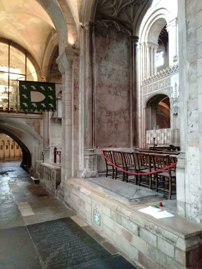 The interior of a medieval cathedral with stone arches and a tomb, highlighting the fascinating Middle Ages.