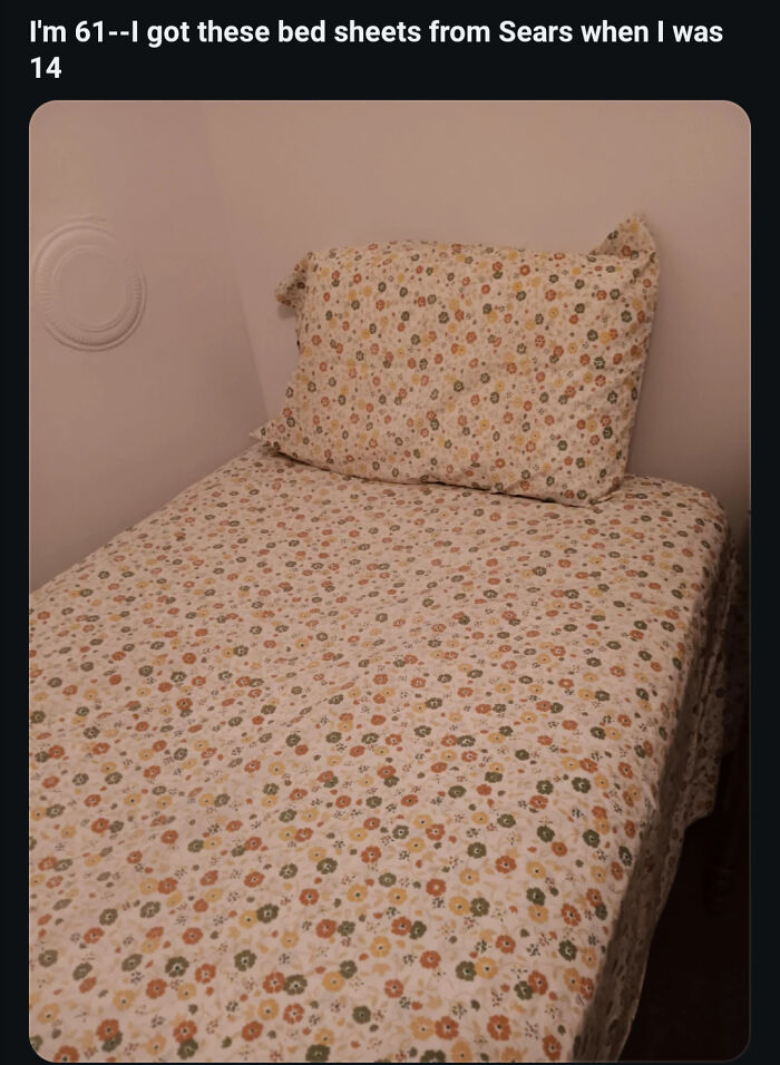 A single bed with floral sheets, highlighting the longevity of old products versus modern consumerism.
