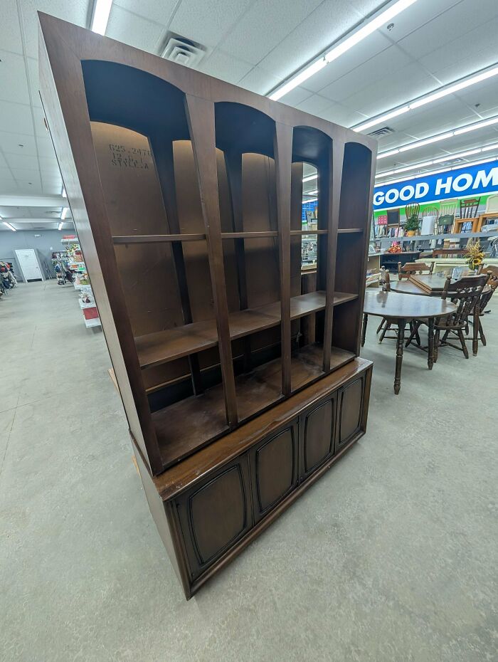A large wooden china cabinet with shelves, a great find at the thrift store.