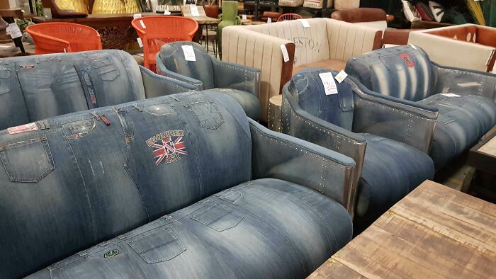 Sofas and chairs designed to look like denim jeans, showcasing ridiculous pieces of furniture in a store setting.