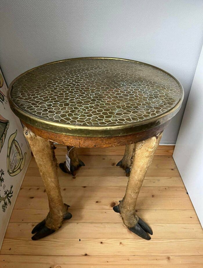 Table with animal legs as furniture, showcasing one of the most ridiculous pieces of furniture people stumbled upon online.