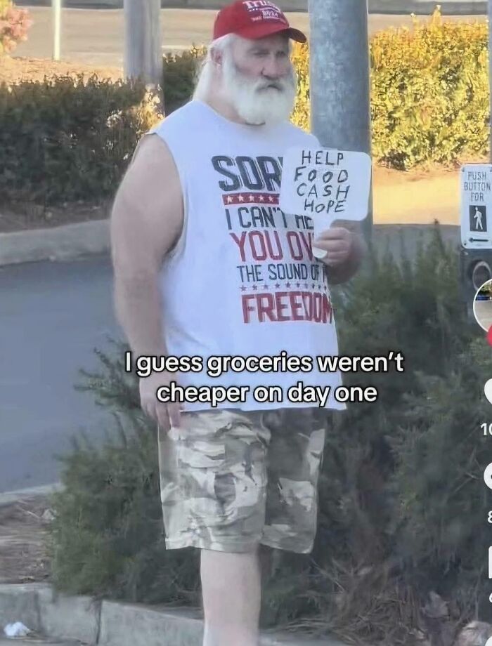 Man wearing a red cap and sleeveless shirt holding a sign asking for help, illustrating consequences of supporting the wrong side.