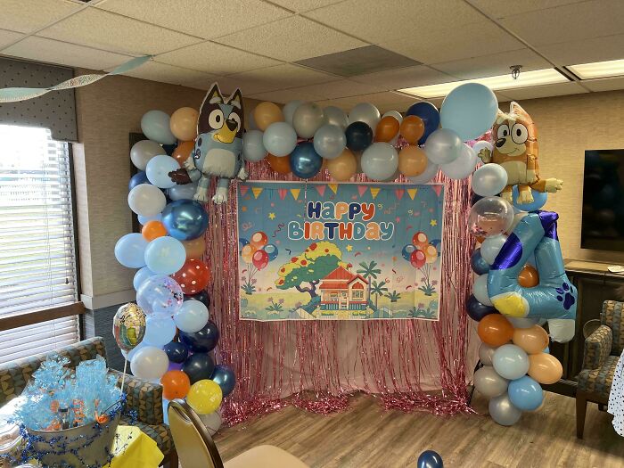 A room decorated with balloons and a Happy Birthday banner, highlighting the wholesome, funny, and goofy side of a great dad.