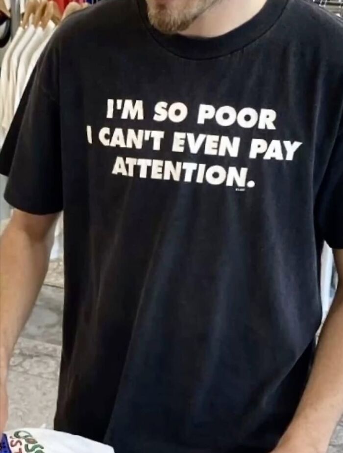Man wearing a black shirt with a funny quote, showcasing one of the weirdly hilarious images to improve your feed and mood.