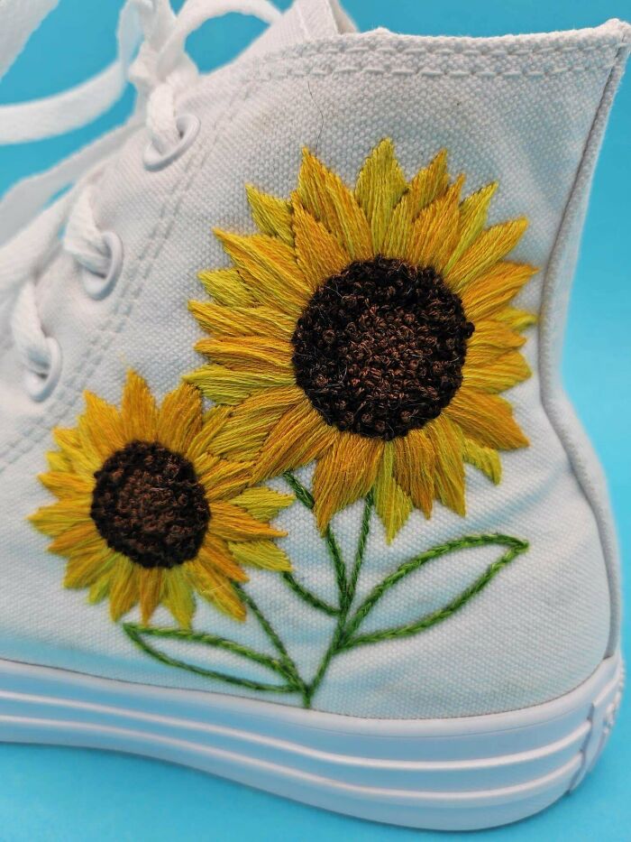 White sneaker with detailed DIY embroidered sunflowers on the side, showcasing creative DIY wins and handmade craftsmanship.