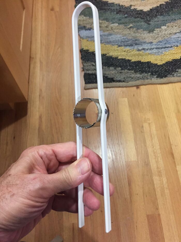 Hand holding a small kitchen tool with a serrated circular blade, one of many interesting tools solving annoying problems.