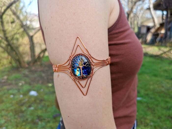 Amazing photos showcasing an intricate copper wire arm cuff with a tree of life design, new pics of unique jewelry.