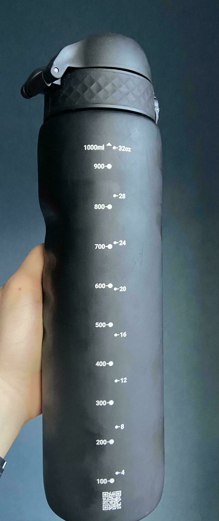 A funny fail showing a black water bottle with incorrectly aligned measurement markings.